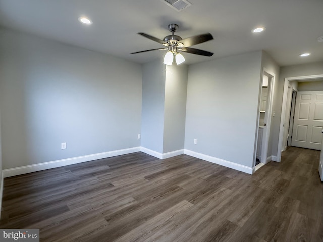 spare room featuring ceiling fan and dark hardwood / wood-style flooring