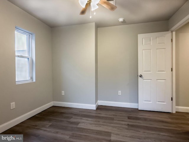 spare room featuring dark hardwood / wood-style floors and ceiling fan