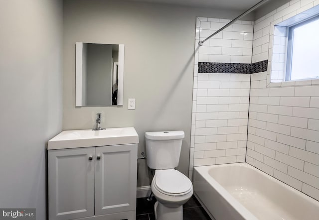 full bathroom featuring tiled shower / bath combo, vanity, and toilet