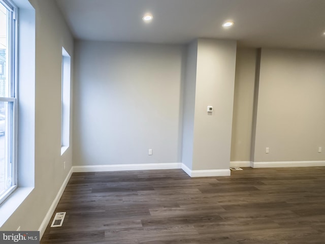 unfurnished room featuring dark wood-type flooring