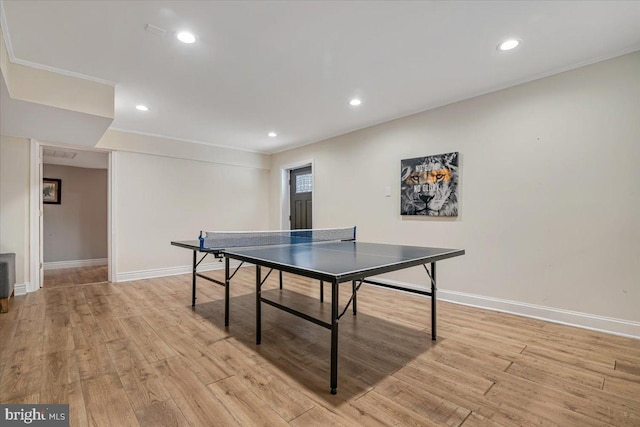 game room with light hardwood / wood-style flooring