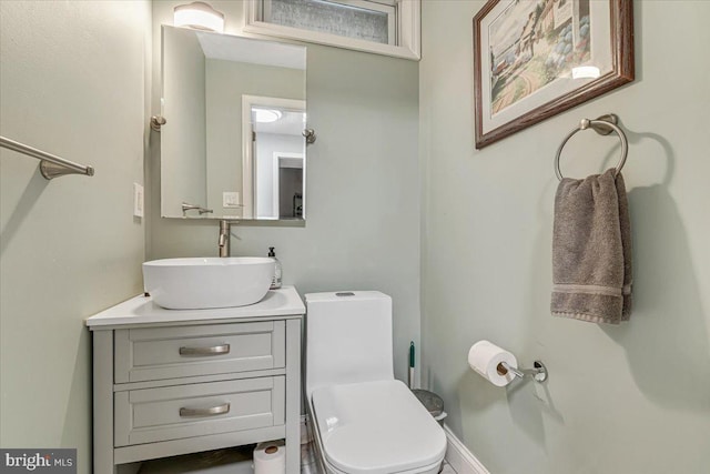 bathroom featuring toilet and vanity