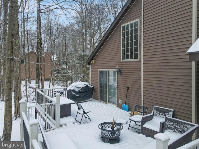 exterior space featuring an outdoor fire pit and a grill