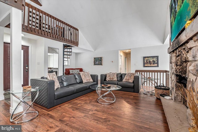 living room featuring high vaulted ceiling and dark hardwood / wood-style flooring