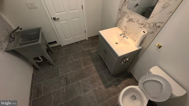 bathroom featuring toilet and vanity