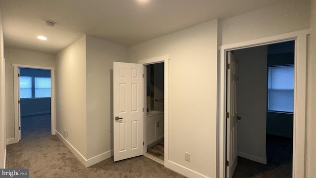 hallway with carpet flooring