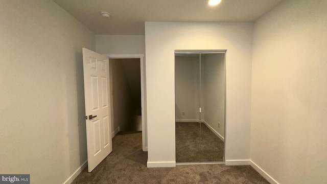 unfurnished bedroom with dark colored carpet