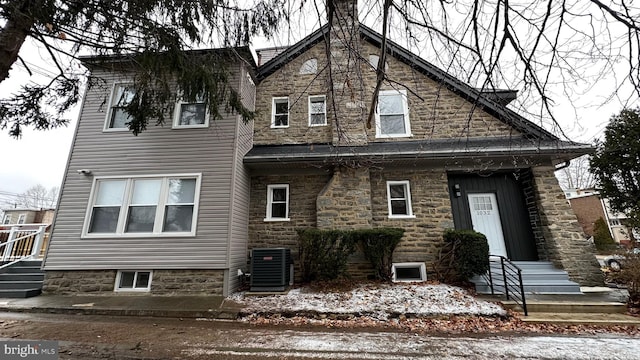 rear view of property with central AC