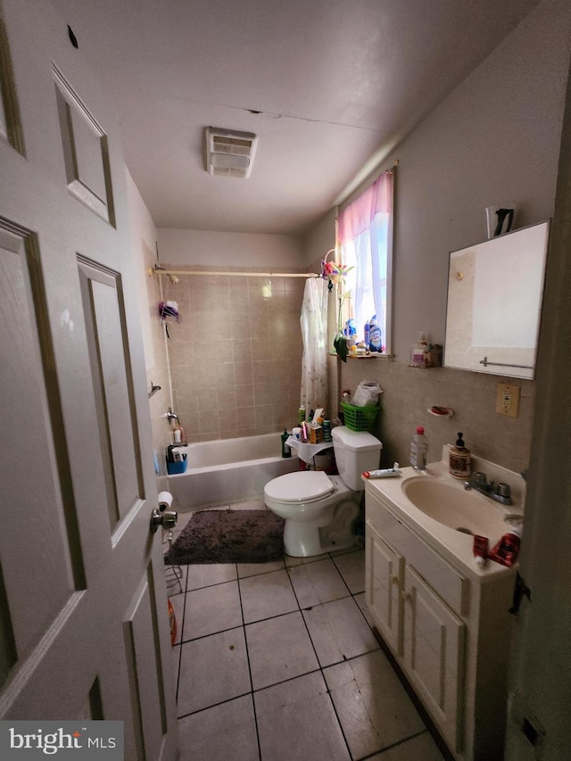 full bathroom featuring toilet, shower / bathtub combination with curtain, tile patterned floors, and vanity