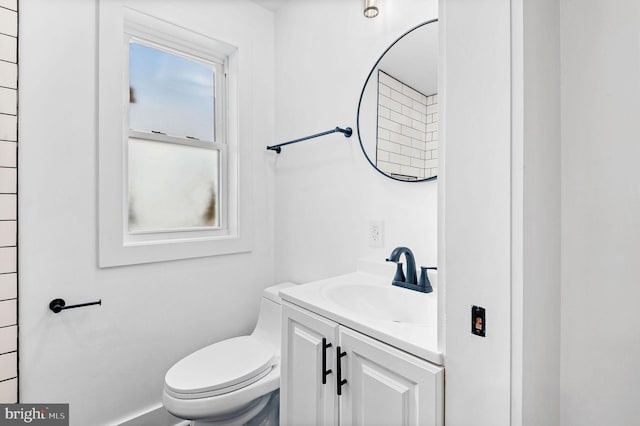 bathroom with toilet and vanity