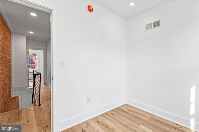 spare room featuring hardwood / wood-style flooring