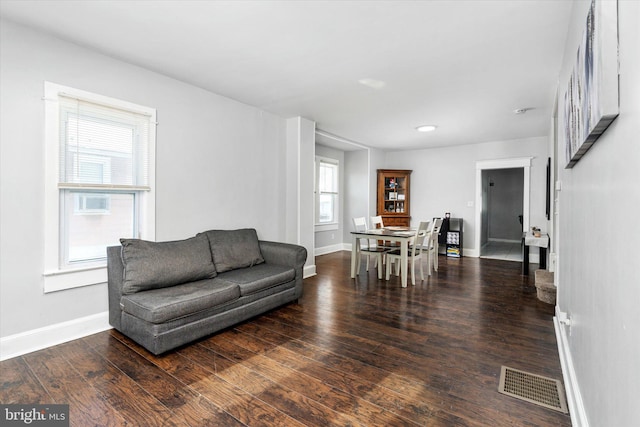 living room with dark hardwood / wood-style flooring