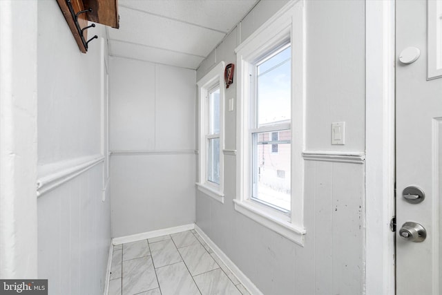 interior space with a paneled ceiling