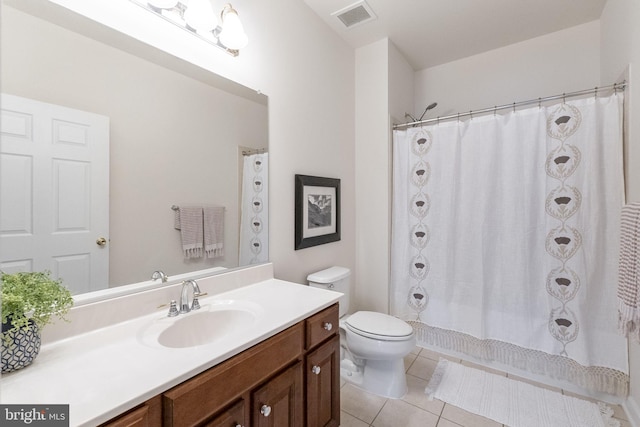 bathroom featuring tile patterned floors, vanity, and toilet