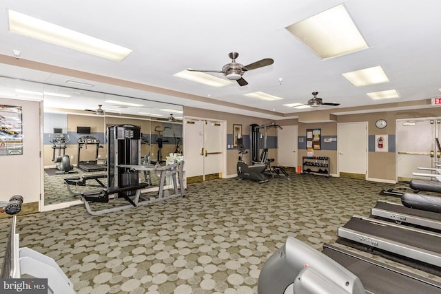 gym with ceiling fan and dark colored carpet