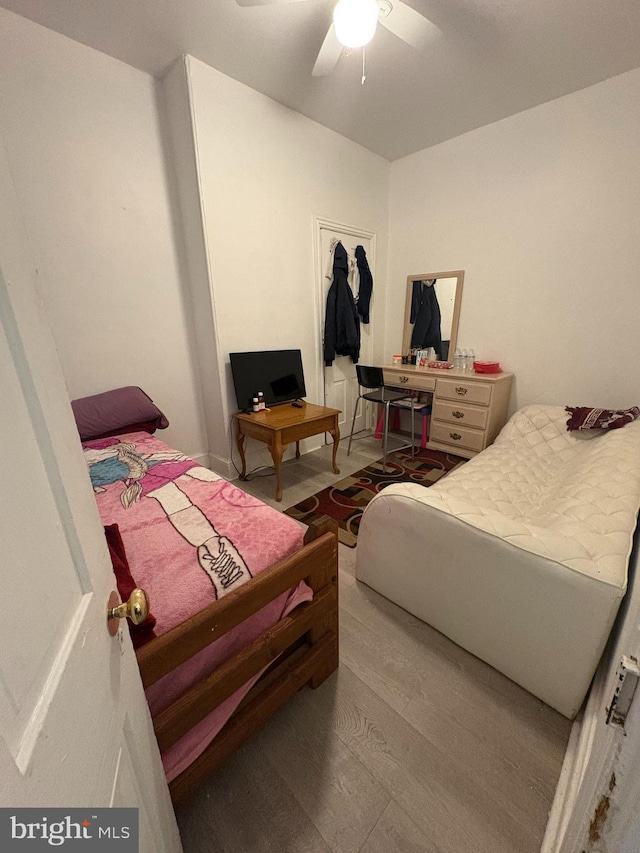 bedroom with ceiling fan and light hardwood / wood-style floors