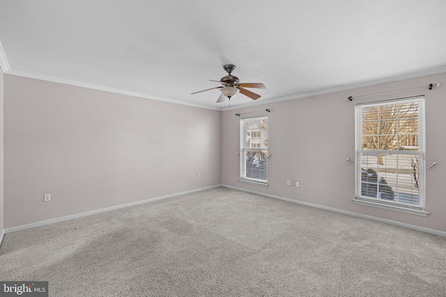 spare room featuring ornamental molding, light colored carpet, and ceiling fan