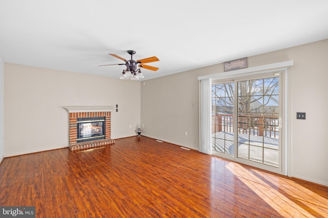 unfurnished living room featuring ceiling fan, a fireplace, and hardwood / wood-style floors