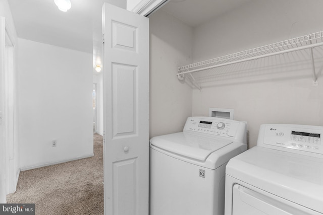 washroom with separate washer and dryer and light colored carpet