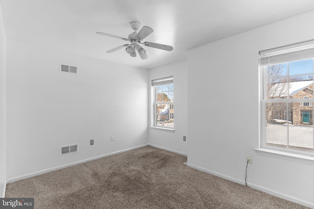 carpeted empty room featuring ceiling fan