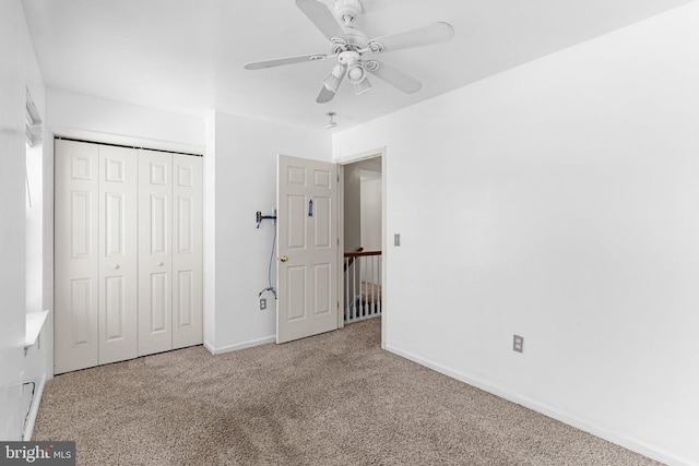 unfurnished bedroom with light carpet, ceiling fan, and a closet