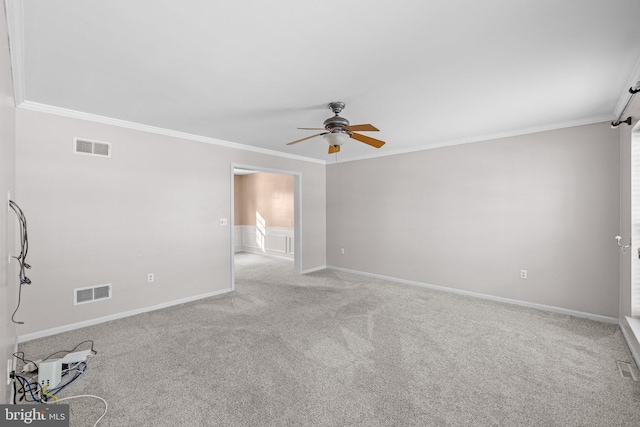 unfurnished room featuring crown molding, light colored carpet, and ceiling fan