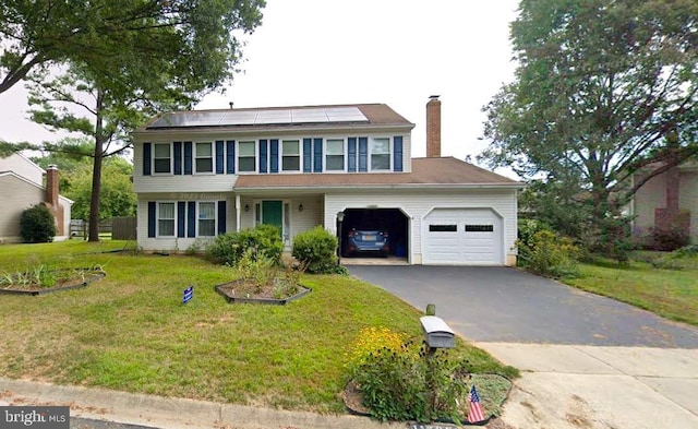 colonial house featuring a garage, a front lawn, and solar panels