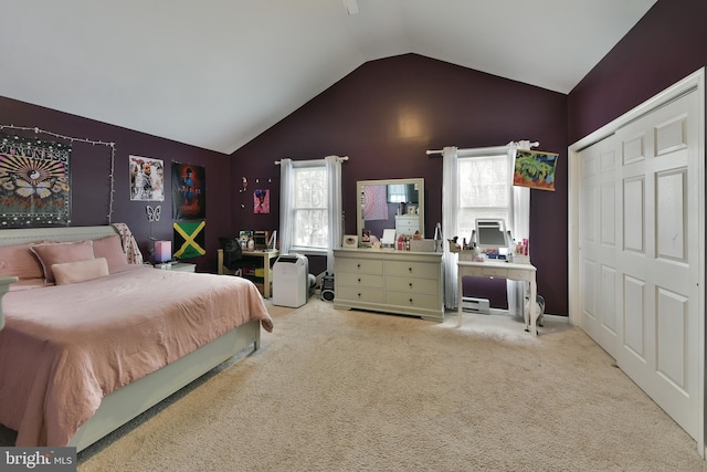 carpeted bedroom featuring lofted ceiling and a closet