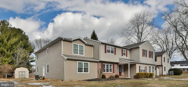 view of front of home with cooling unit and a storage unit