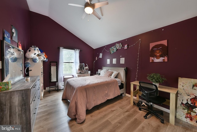 bedroom with ceiling fan, vaulted ceiling, and light hardwood / wood-style flooring