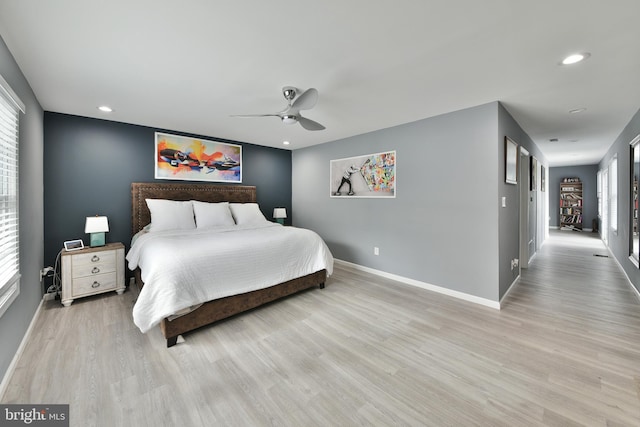 bedroom with light hardwood / wood-style flooring and ceiling fan