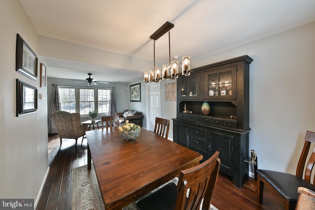 dining space with dark hardwood / wood-style floors and a notable chandelier