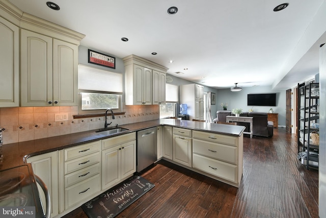 kitchen featuring sink, dark hardwood / wood-style flooring, kitchen peninsula, dishwasher, and cream cabinetry