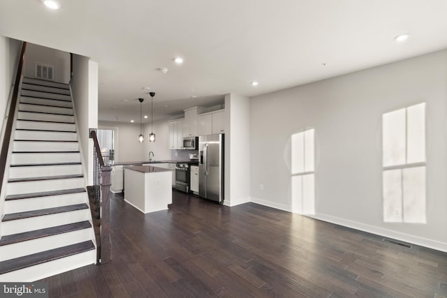 unfurnished living room with dark hardwood / wood-style floors and sink