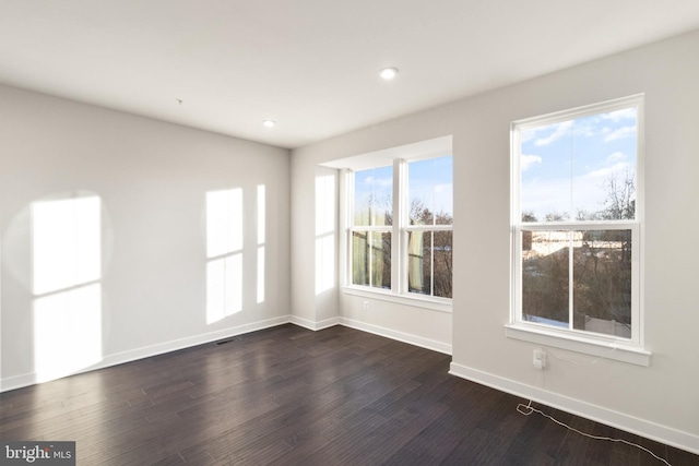 unfurnished room featuring dark wood-type flooring