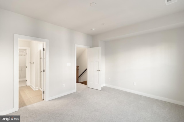 unfurnished bedroom featuring light carpet