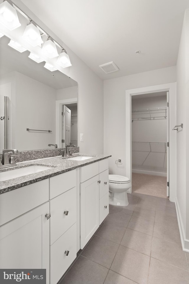 bathroom with tile patterned floors, vanity, and toilet