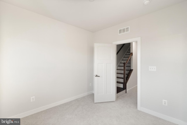 empty room featuring light colored carpet