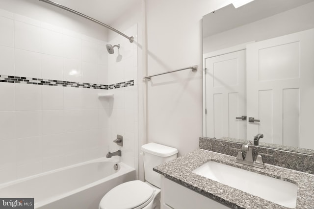 full bathroom featuring toilet, tiled shower / bath combo, and vanity