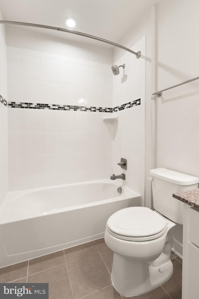 full bathroom with toilet, tiled shower / bath combo, tile patterned floors, and vanity