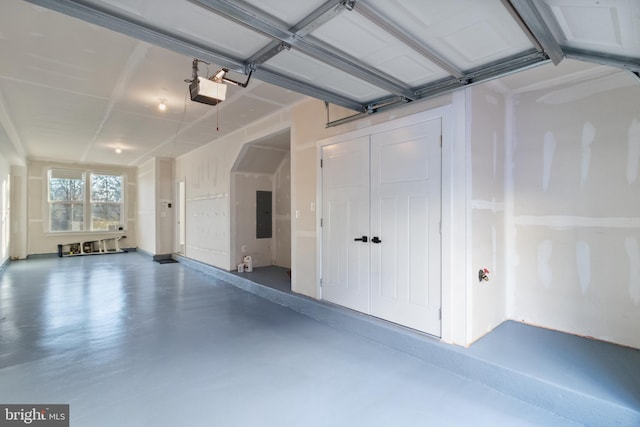 garage featuring electric panel and a garage door opener