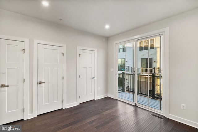 unfurnished room featuring dark hardwood / wood-style floors