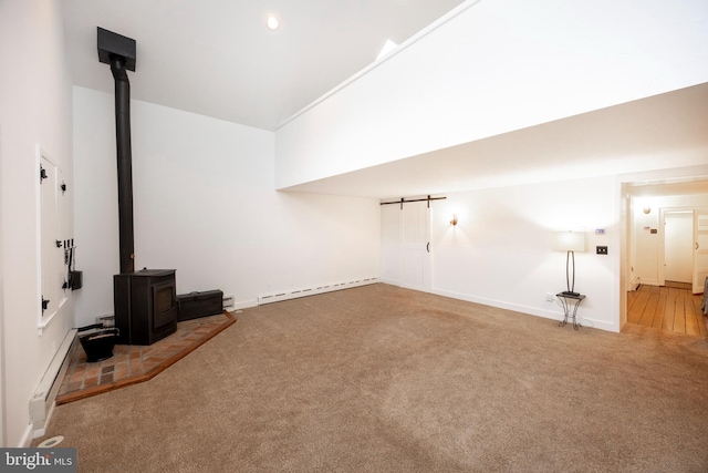 unfurnished living room with high vaulted ceiling, a wood stove, a baseboard radiator, and carpet floors