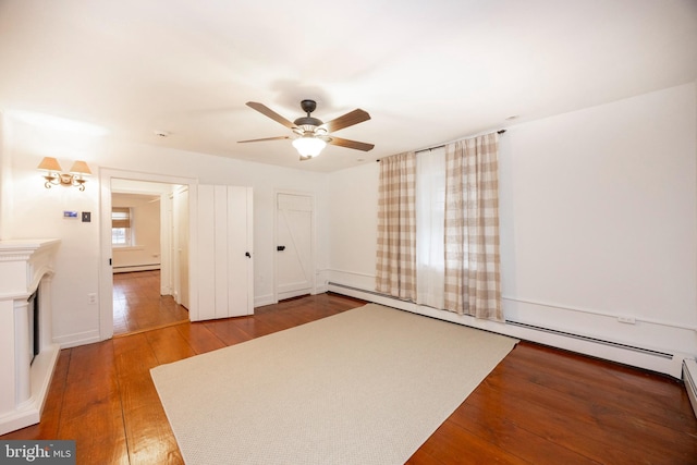 empty room with ceiling fan, hardwood / wood-style floors, and a baseboard radiator