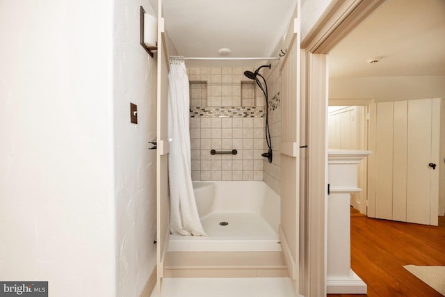 bathroom featuring a shower with shower curtain and wood-type flooring