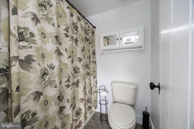 bathroom featuring toilet, tile patterned flooring, and curtained shower