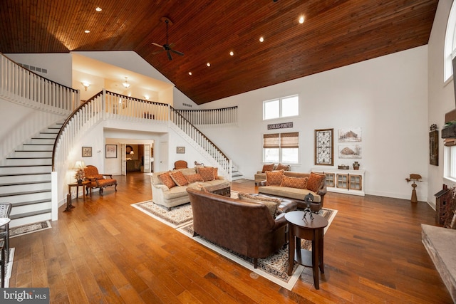 living room featuring hardwood / wood-style flooring, a high ceiling, ceiling fan, and wood ceiling