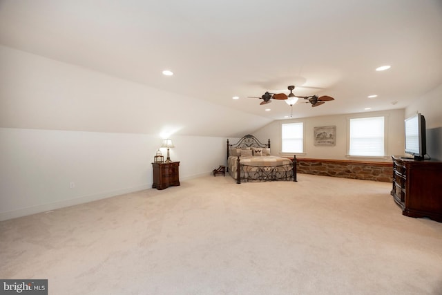 bedroom featuring light carpet, ceiling fan, and vaulted ceiling