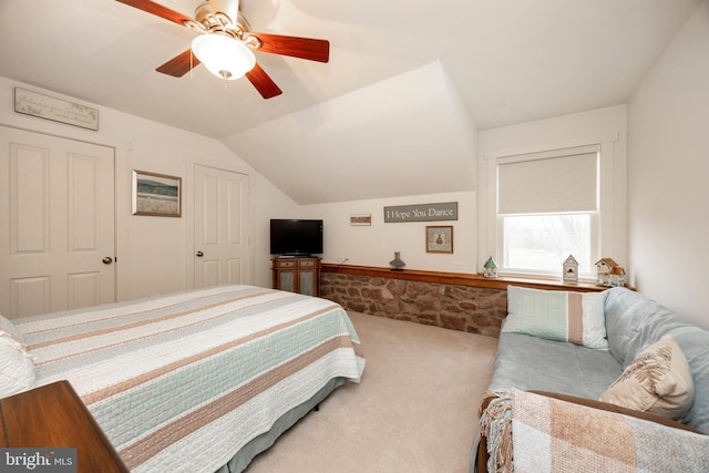 bedroom with carpet floors, ceiling fan, and vaulted ceiling