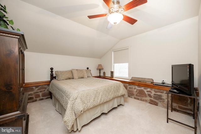 carpeted bedroom with ceiling fan and lofted ceiling